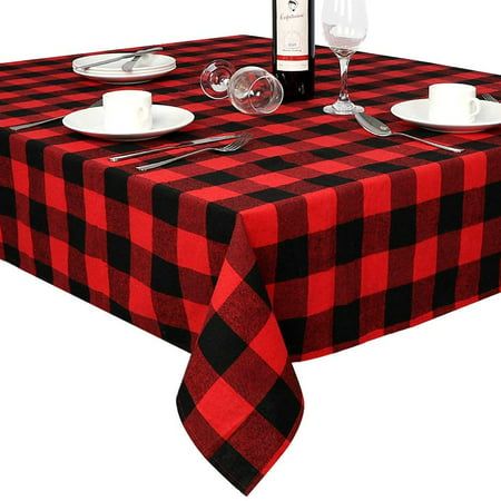 a red and black checkered table cloth with place settings