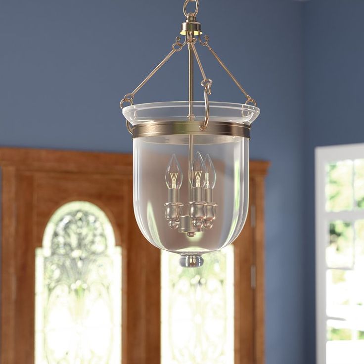 a chandelier hanging from the ceiling in a room with blue walls and windows