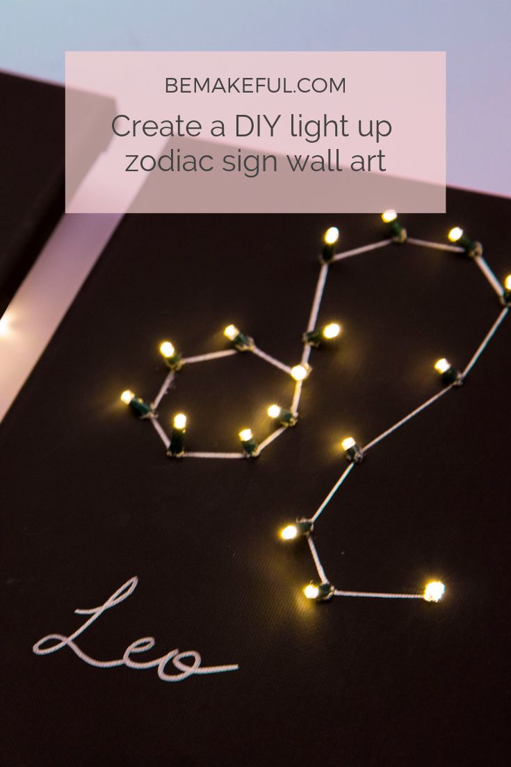 the word leo written in white lights on a black surface with an image of zodiac signs