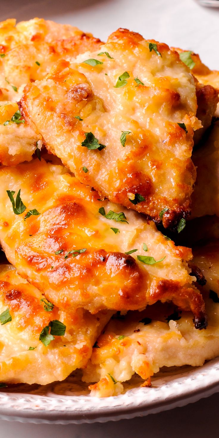 cheesy chicken patties are piled on top of each other