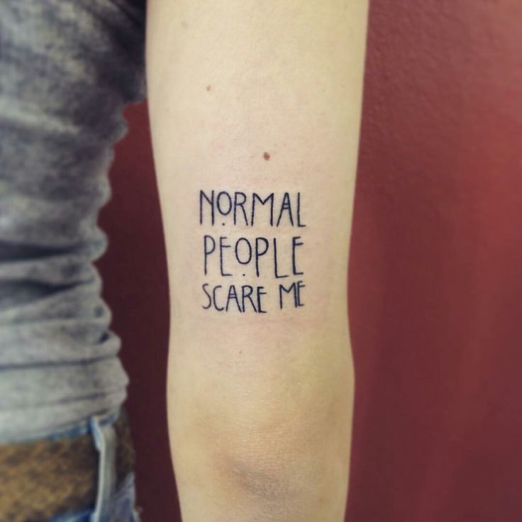 a woman's arm with the words normal people scare me tattooed on her left arm