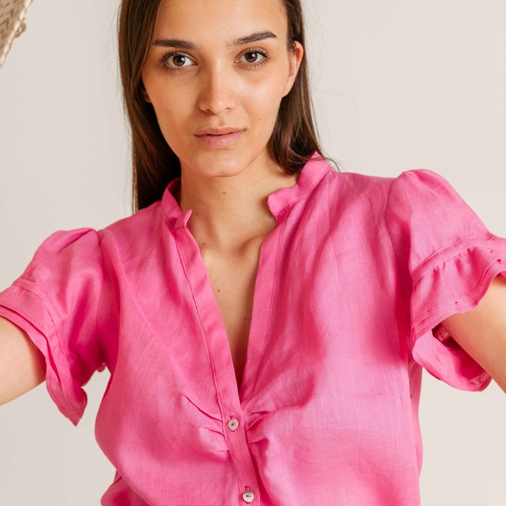 PRODUCT DETAILS Olivia Linen Top - romantic, light, airy, and available in vibrant spring/summer colors. Perfect for any summer look, this shirt combines effortless style with the breezy comfort of linen. Elevate your wardrobe with Olivia's pop of color. Designed in New York City. Sustainably made in Bosnia & Herzegovina. FIT & SIZING The delicate ruffle sleeve detailing adds a touch of charm. Model is 179cm / 5’ 101/2’’ and wears size S/M. FABRIC & CARE 100% high-quality linen 30°C machine wash Breezy Linen Tops For Summer, Feminine Pink Shirt For Summer, Feminine Pink Summer Shirt, Feminine Summer Shirt For Day Out, Feminine Summer Day Out Shirt, Chic Summer Linen Blouse, Feminine Linen Blouse For Vacation, Feminine Linen Blouse For Summer, Feminine Linen V-neck Blouse