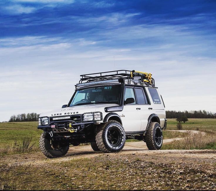 an off road vehicle parked on a dirt road