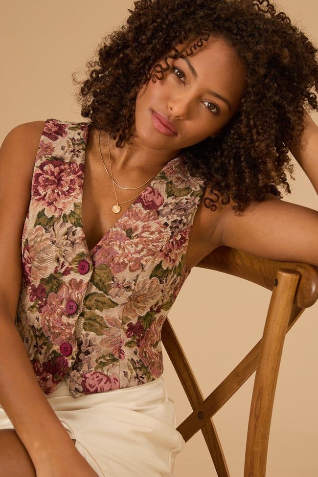 This vibrant piece adds a touch of boho charm to any outfit, whether you're exploring the city or sipping coffee on a sunny day. Perfect for layering over your favorite tops or dresses, this vest is a must-have. Chic Multicolor Floral Embroidered Tops, Chic Multicolor Top With Floral Embroidery, Chic Multicolor Tops With Floral Embroidery, Spring Floral Print V-neck Vest, Bohemian Tank Top With Floral Embroidery, Bohemian Spring Tank Top For Day Out, Bohemian Tank Top For Spring Day Out, Bohemian Tank Top For Day Out In Spring, Bohemian Style Summer Vest For Day Out