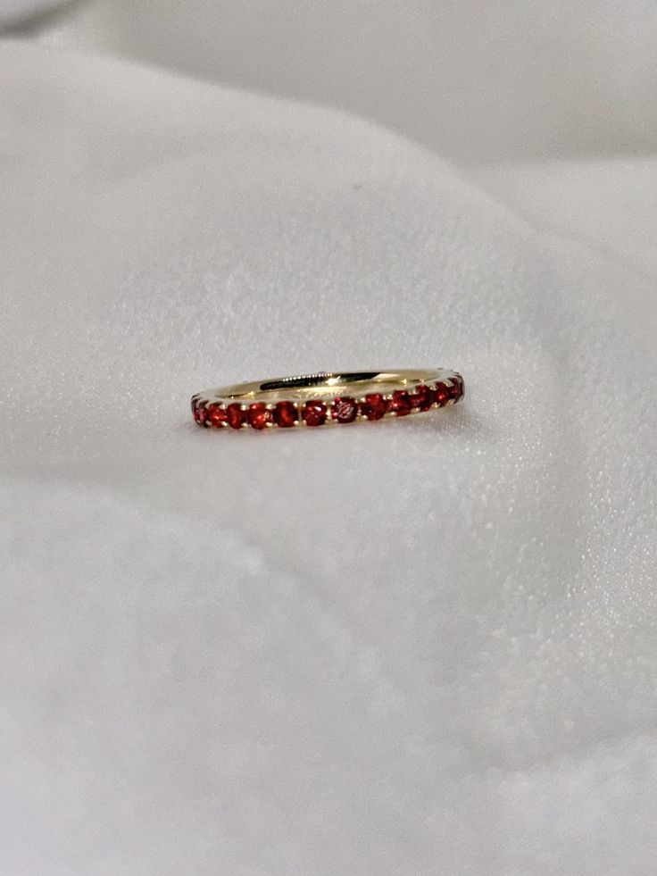 "A timeless and classic design, symbolizing commitment and love. Perfect for everyday wear or dressed up for special occasions. Make a bold statement in our Genuine Garnet Eternity Ring, handcrafted in 14k yellow gold. This ring is not adjustable and is available in US size 7 1/4.  Item Specifications: Materials: 14k Solid Yellow Gold Gemstone: Natural Garnet Total Gold Weight: 2.06 ct. Total Garnet Carat Weight: 1.22 ct.  ★  Each order will be beautifully packaged in a jewelry box and comes with a drawstring pouch that's perfect for travel. LiebeJewelry's products are handcrafted and all materials are genuine and ethically sourced. Our products are made with genuine materials and will not tarnish in the shower or irritate the skin. If you have any additional questions about this ring, jus Oval 14k Gold Eternity Band, Luxury Ruby Half Eternity Ring, Luxury Ruby Ring With Half Eternity Round Cut, Luxury Ruby Eternity Band As A Gift, Ruby Eternity Band For Anniversary, Luxury Ruby Half Eternity Ring For Anniversary, Ruby Eternity Band With Prong Setting For Formal Occasions, Yellow Gold Ruby Round Cut Eternity Band, Formal Ruby Eternity Band With Prong Setting