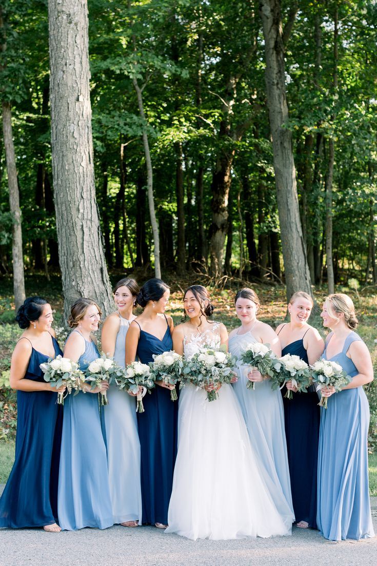 Bride with her Bridemaids dressed in different shades of blue Rustic Bridesmaid Dresses Blue, Bride And Blue Bridesmaids, Saphire Dresses Bridesmaid, Blue Themed Wedding Dress, Blue Wedding Theme Indian, Brides Made Dresses Blue, Blue Dresses For Bridesmaid, Blue Shades Wedding Theme, Bestmaids Dresses