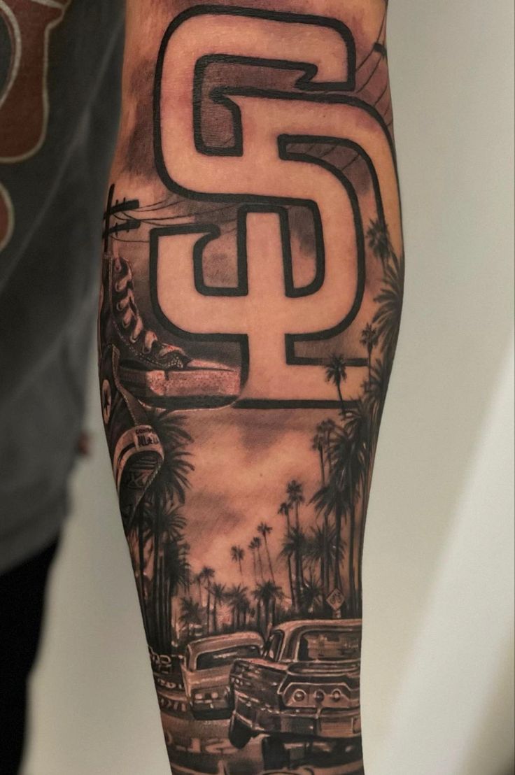 a man's arm with an old school style san diego tattoo design on it