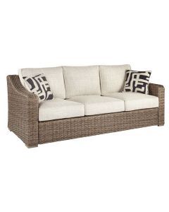 a wicker couch with pillows on the top and bottom, in front of a white background