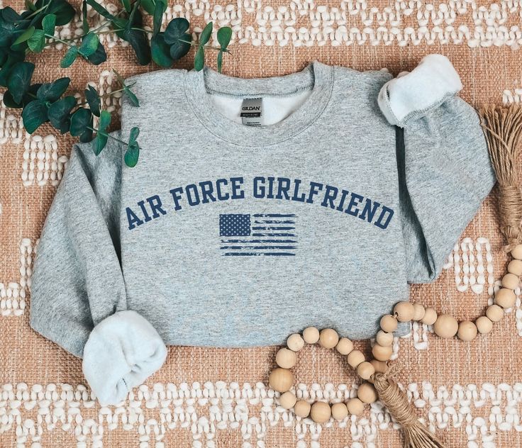 If you're looking for a proud Air Force girlfriend sweatshirt, this cozy Airforce girlfriend sweater is perfect! This ultra soft Air Force girlfriend shirt makes a great Military girlfriend gift to wear during Air Force graduation and all year round! ✺ CHECK OUT more like this in our MILITARY FAMILY section: https://www.etsy.com/shop/sagicrabboutique/?etsrc=sdt&section_id=46657362 ✺  WANT SOMETHING PERSONALIZED OR DON'T SEE THE COLORS YOU WANT?  If you're interested in customizing something or would like to make a small change to a design/colors, send us message and we'll be happy to work with you. ◡̈  ABOUT TANK TOPS  ✺ Racerback cut ✺ Slim fit ✺ 60% cotton, 40% polyester ✺ Extra-light fabric ✺ Tear-away label ✺ Run smaller DUE TO THEIR SLIM FIT, THESE TANK TOPS RUN SMALLER SO IT IS RECOM Air Force Girlfriend Quotes, Airforce Girlfriend, Air Force Girlfriend Shirts, Air Force Graduation, Military Girlfriend Pictures, Military Girlfriend Army, Air Force Girlfriend, Girlfriend Shirt, Airforce Wife