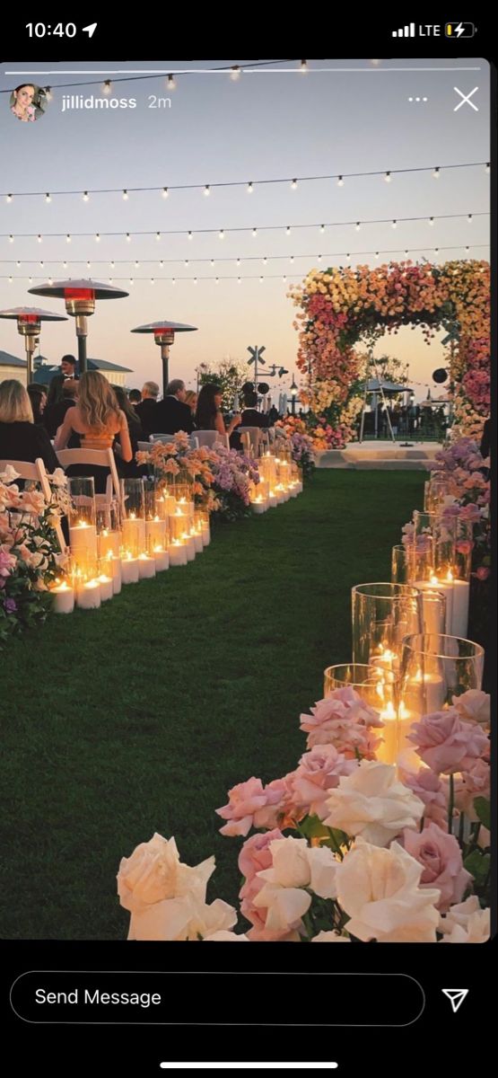 an outdoor wedding with candles and flowers