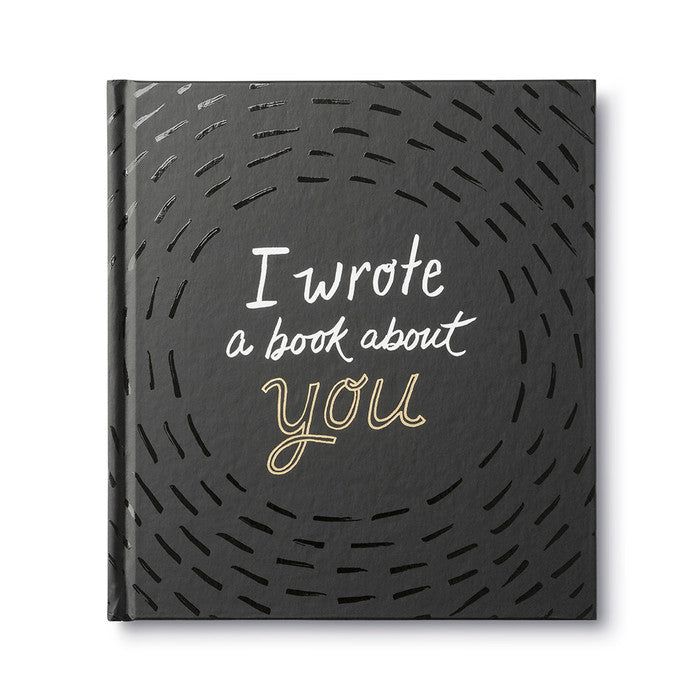 i wrote a book about you written in gold ink on a black background with an abstract pattern