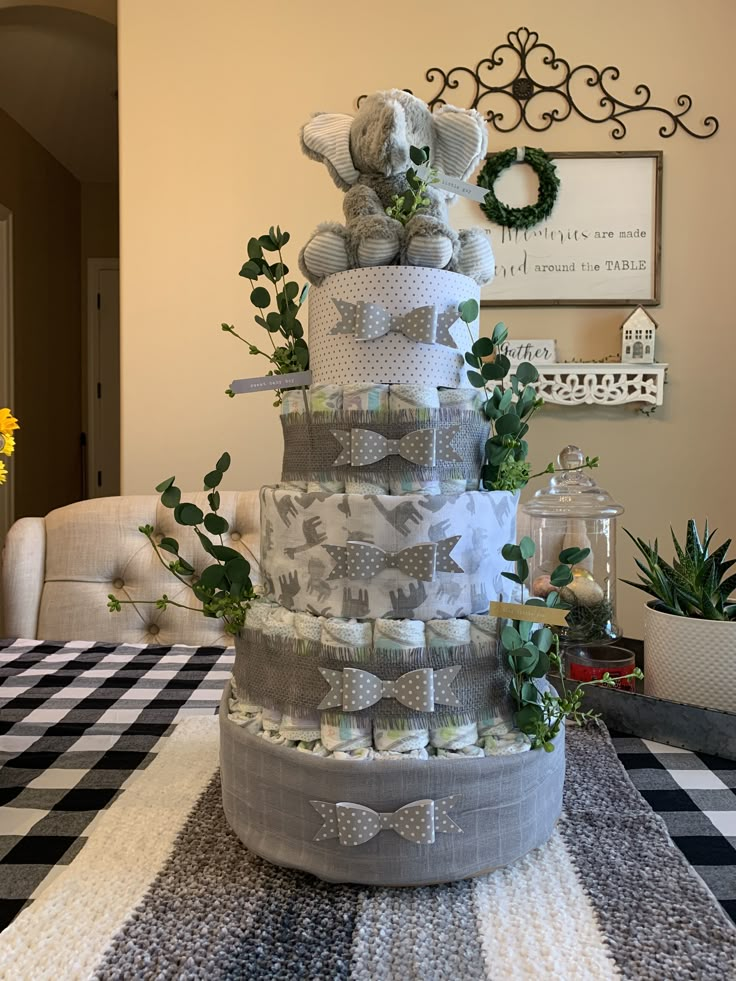 a large stack of diapers sitting on top of a black and white checkered table cloth