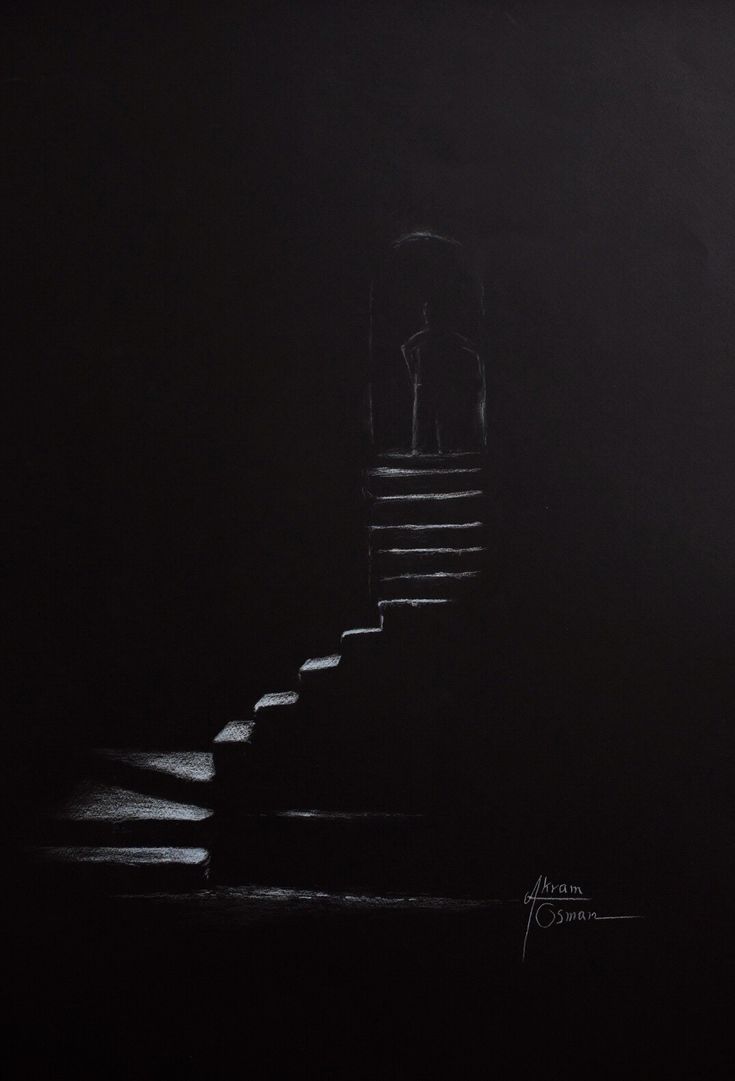 the stairs are lit up at night with light coming in from behind them, and there is only one person standing on it