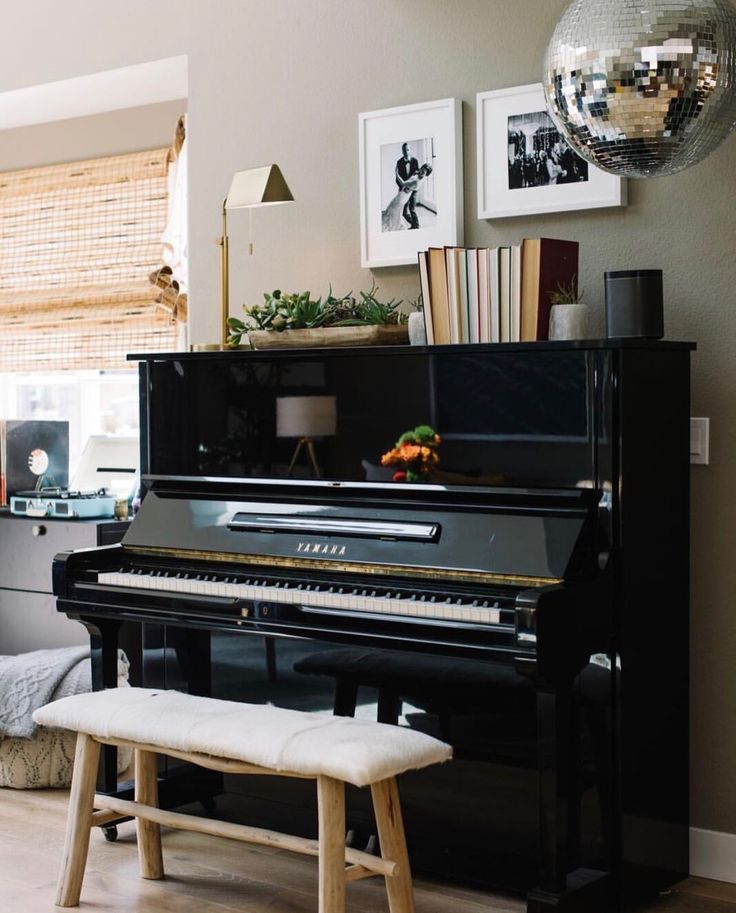 a black piano sitting in the middle of a living room