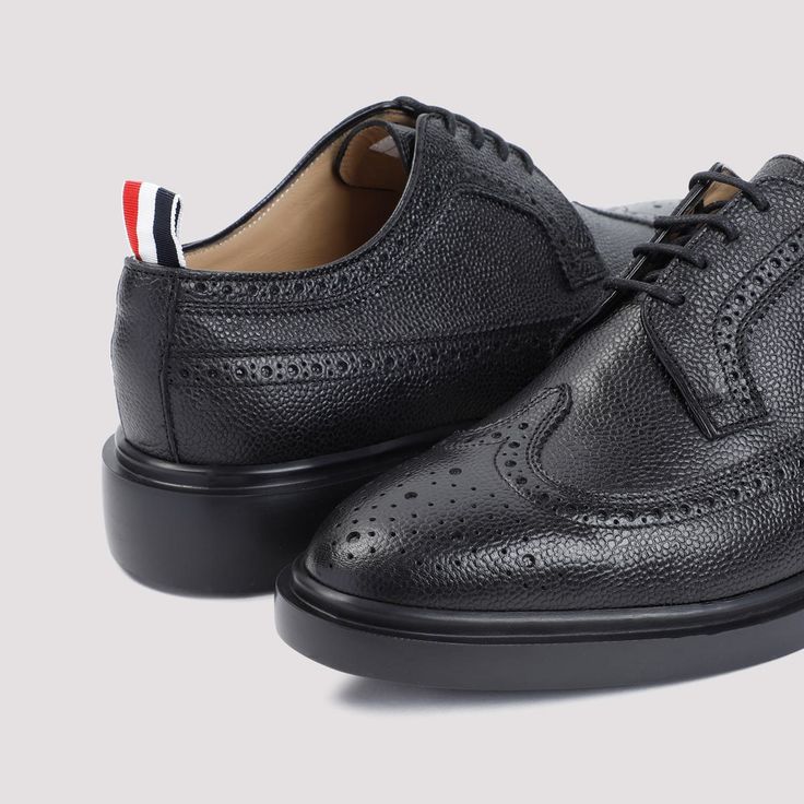 Thom Browne Longwing Black Calf Leather Brogues. Crafted from black calf leather, elongated almond toe, lace-up fastening, brogue details, grosgrain loop at the heel, leather lining, leather branded insole and outsole.Gender: MenMaterial: 100%CALF LEATHER 100%RUBBERColor: BlackMade in: ITProduct ID: MFD002H.00198_001*Import tax/duty will be calculated at checkout (If applicable) Thom Browne Shoes, Black Brogues, Caged Sandals, Leather Brogues, Black Tank Dress, Black Aviators, Brogue Shoes, Balenciaga Designer, Mens Oxfords