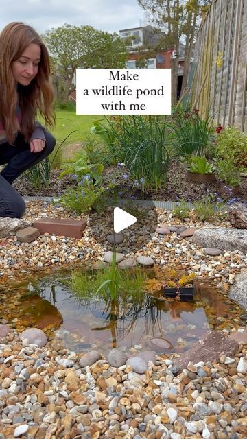 a woman kneeling down next to a small pond