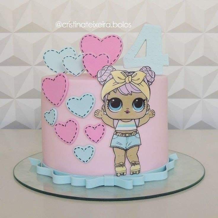 a pink and blue birthday cake with a cartoon character on the top, surrounded by hearts