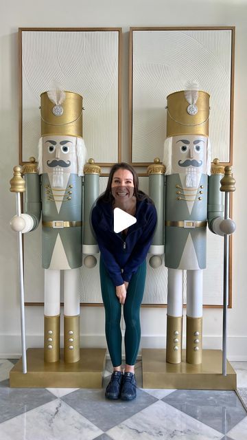 a woman standing in front of two nutcrackers