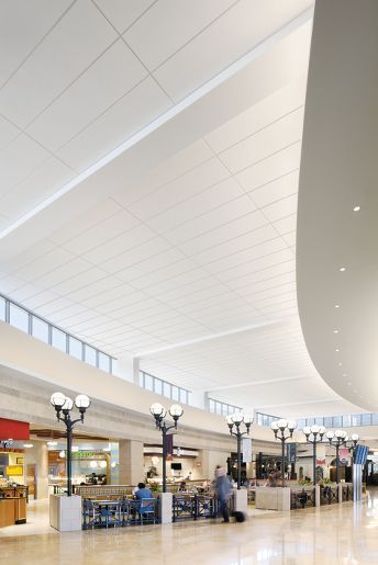 the inside of an airport with people walking around