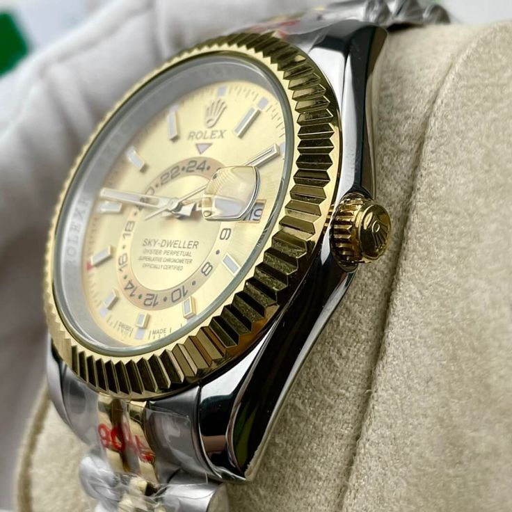 This timepiece is a Rolex Sky-Dweller, distinguished by its two-tone Oystersteel and 18ct yellow gold construction. The champagne dial features the iconic off-center 24-hour disc for dual time zone display, and an annual calendar. The watch is powered by the Calibre 9001, a complex self-winding mechanical movement. The fluted bezel, Oyster bracelet with Easylink extension, and Superlative Chronometer certification exemplify Rolex's commitment to precision and luxury. This Sky-Dweller is a sophis Formal Yellow Automatic Watch, Luxury Yellow Watches With Subdials, Timeless Yellow Chronometer Watch, Timeless Yellow Watch With Chronometer, Luxury Yellow Watch With Subdials, Gold Chronometer Watch Accessories With Round Dial, Classic Yellow Chronometer Watch, Gold Chronometer Watch With Round Dial, Timeless Watch With Day-date Display