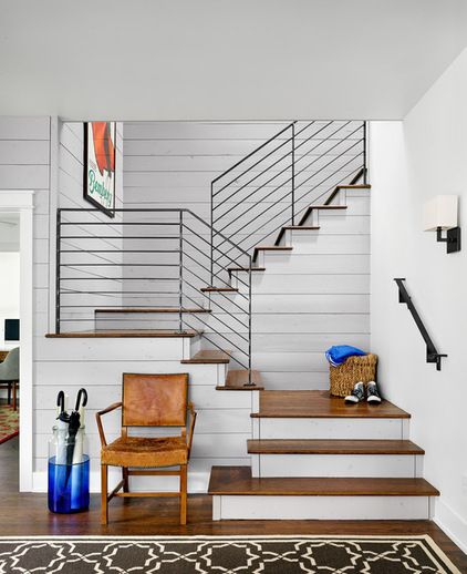 a living room filled with furniture and a stair case