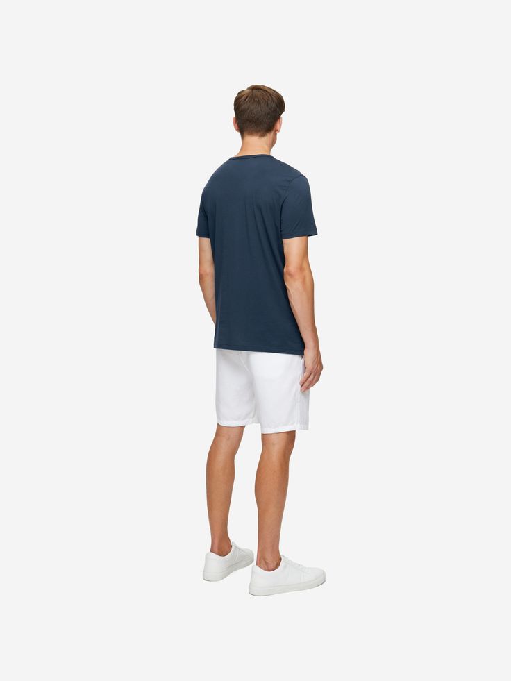 Wear to the beach, after a dip in the pool, whilst lounging or as a cool evening alternative, the Riley tee is incredibly versatile. The short-sleeve crew-neck design has a soft neckband with narrow cover stitching for a refined and comfortable finish and as always, our branding is kept subtle — with a minimalist label tacked at the hem and a printed logo to avoid irritating neck labels.. Our navy blue Riley crew-neck t-shirt is cut from 100% fine gauge Pima cotton for a luxurious essential. It' Relaxed Summer T-shirt For Loungewear, Relaxed Summer Loungewear T-shirt, Sporty Relaxed Fit T-shirt For Summer, Relaxed Short Sleeve T-shirt For Vacation, Relaxed Fit Summer T-shirt, Sporty Crew Neck T-shirt For Summer, Summer Crew Neck T-shirt For Poolside, White Crew Neck Top For Poolside, Relaxed Fit White Tops For Poolside