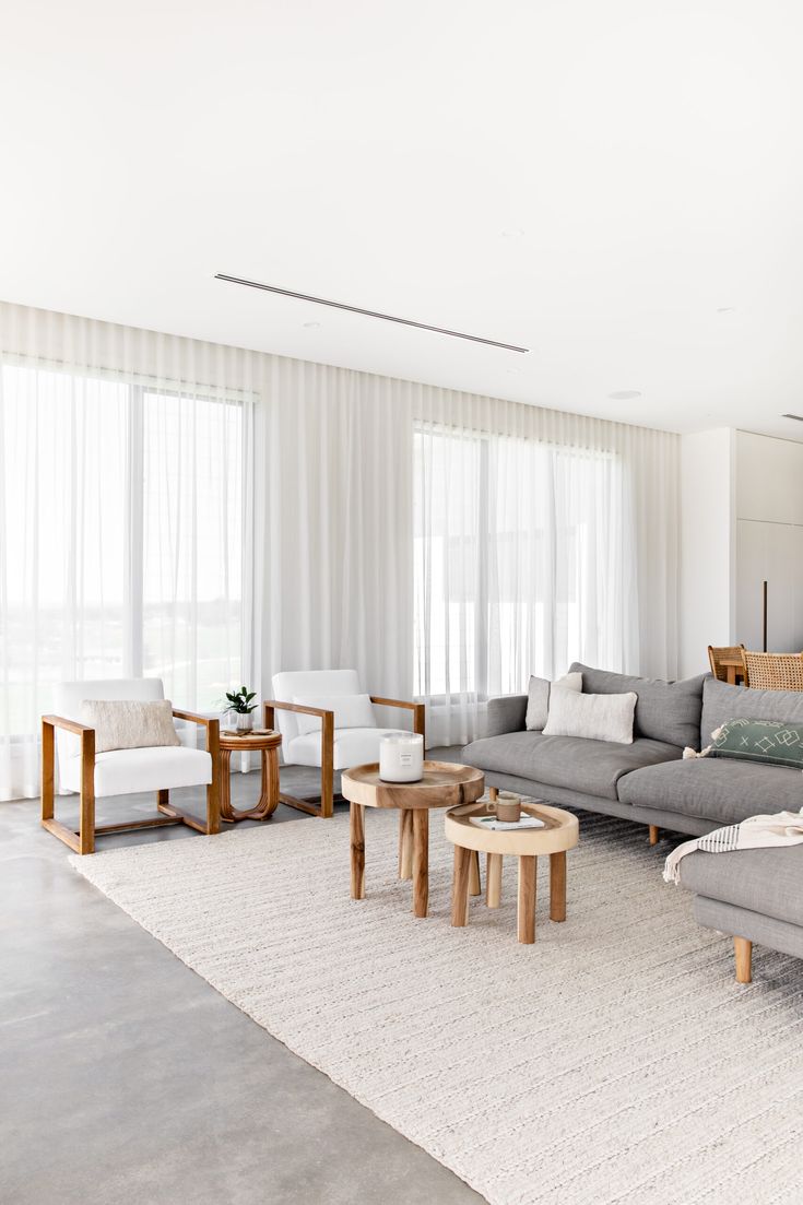 a living room filled with furniture and white walls