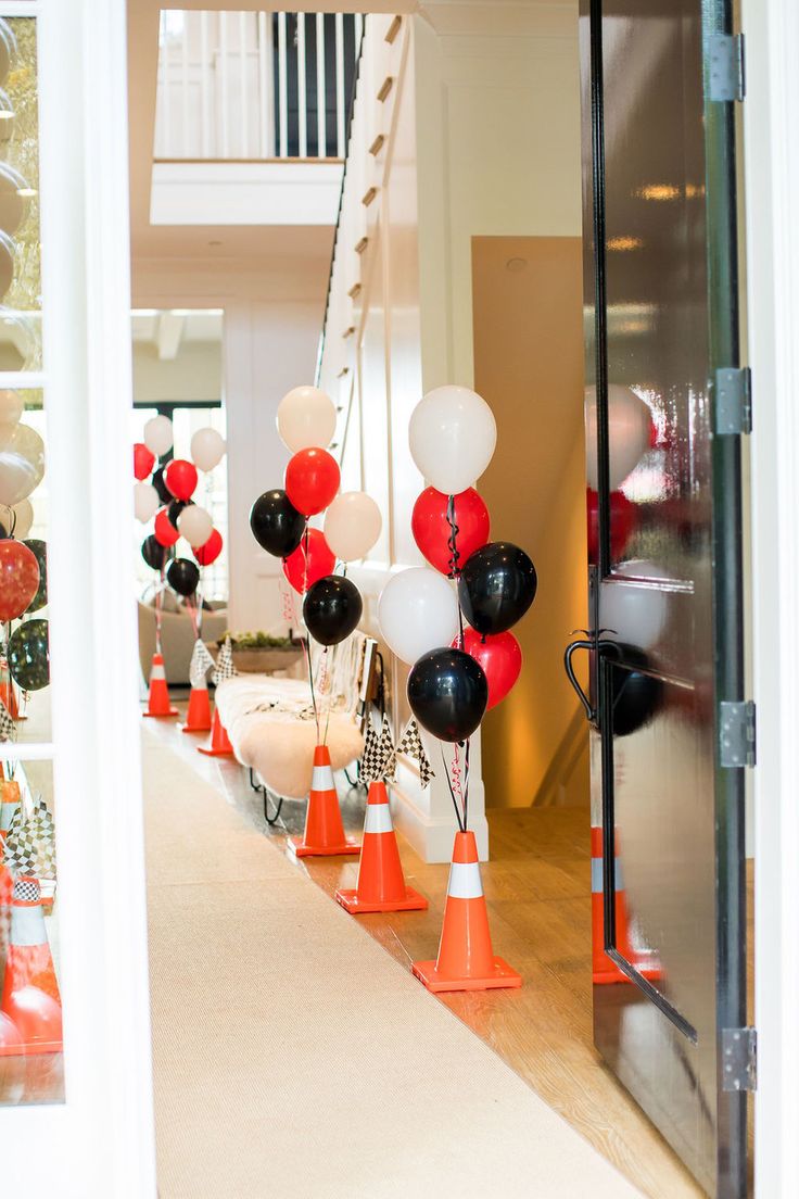 balloons and traffic cones are lined up on the floor