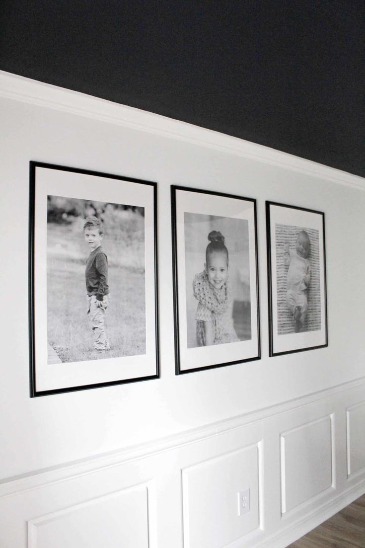 three black and white photos hanging on the wall in a room with wood floors,