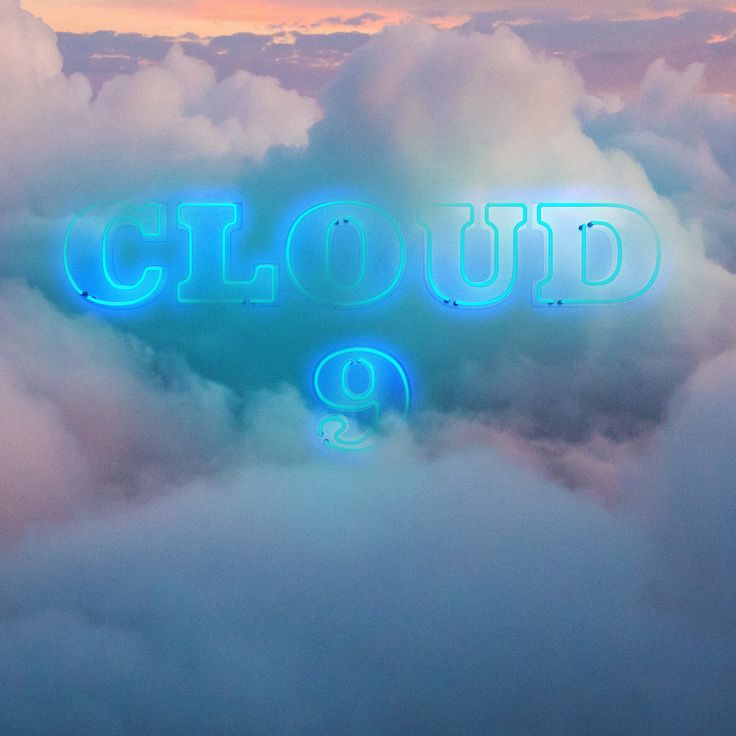 the words cloud 9 are illuminated in blue neon lights above some fluffy clouds at sunset