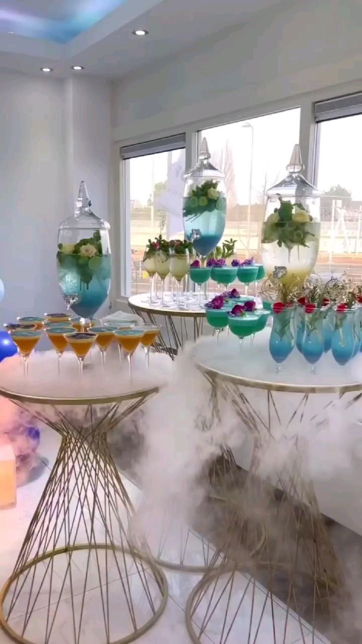 an assortment of desserts and drinks on display at a party