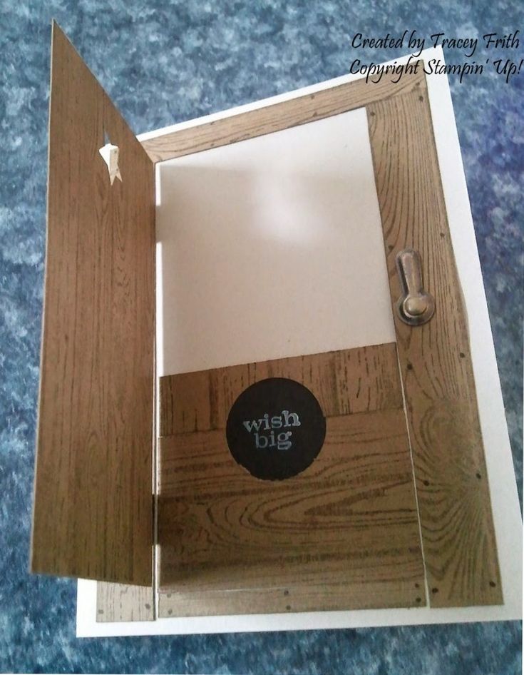 an open wooden box with a black sticker on the bottom and white paper inside