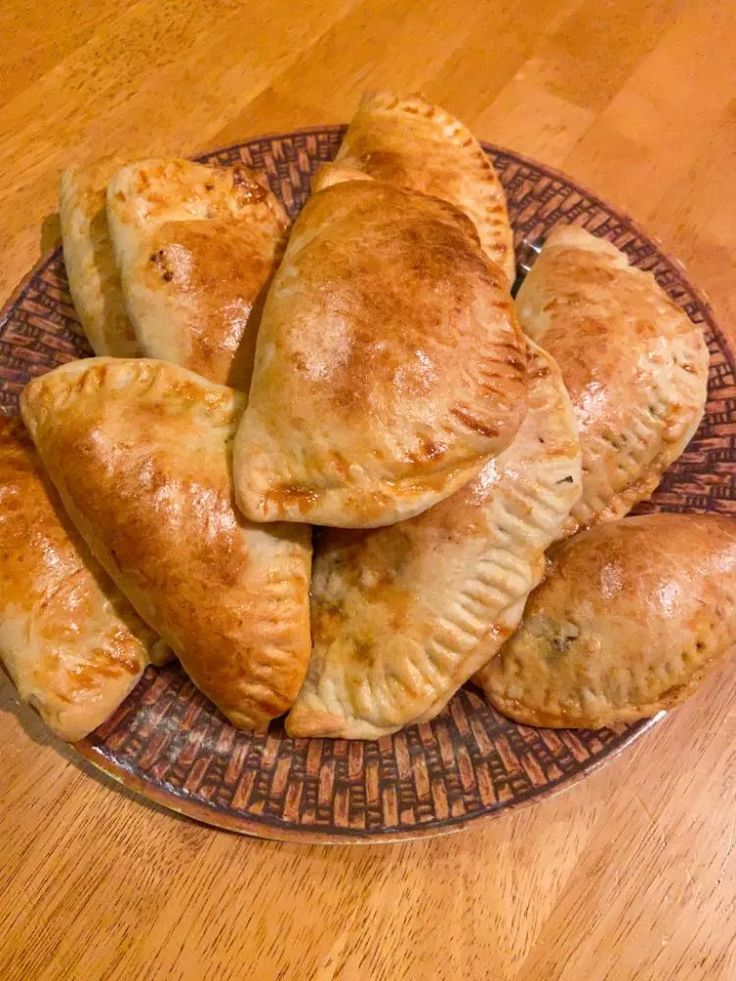 several pastries on a plate sitting on a wooden table