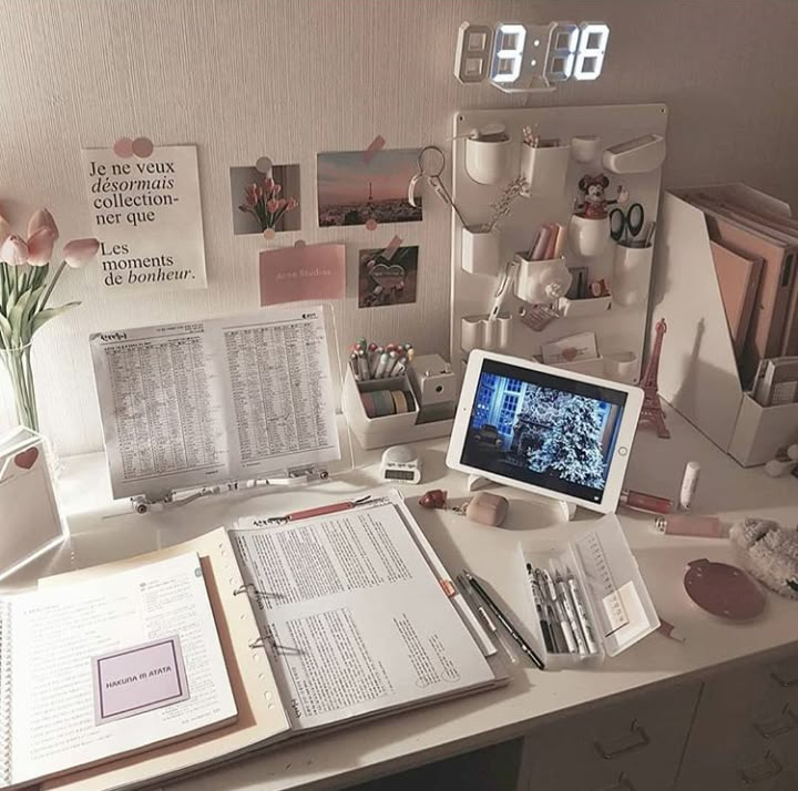 the desk is cluttered with books, papers, and other personal items on it