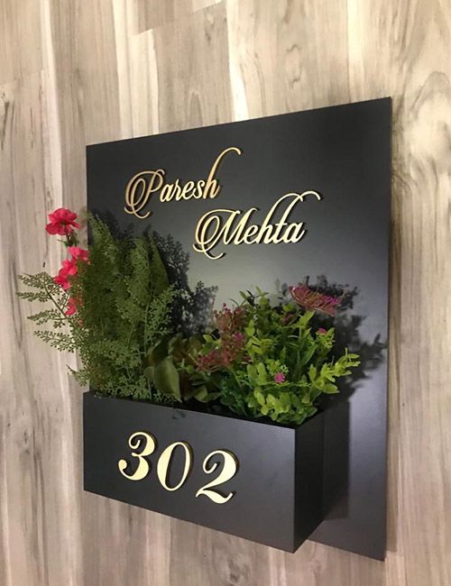 a sign that says paresh mehla on it with flowers in the corner