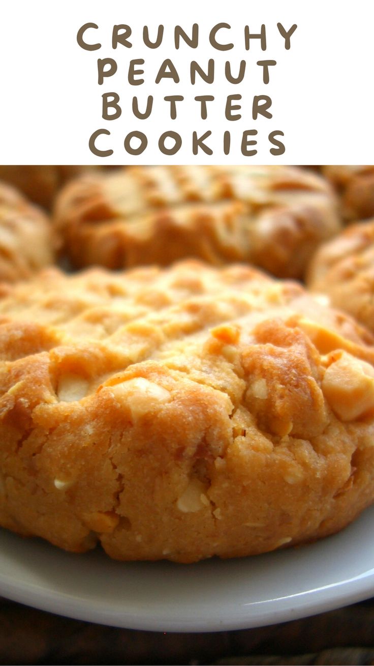 a white plate topped with cookies on top of a wooden table and text overlay reads crunchy peanut butter cookies