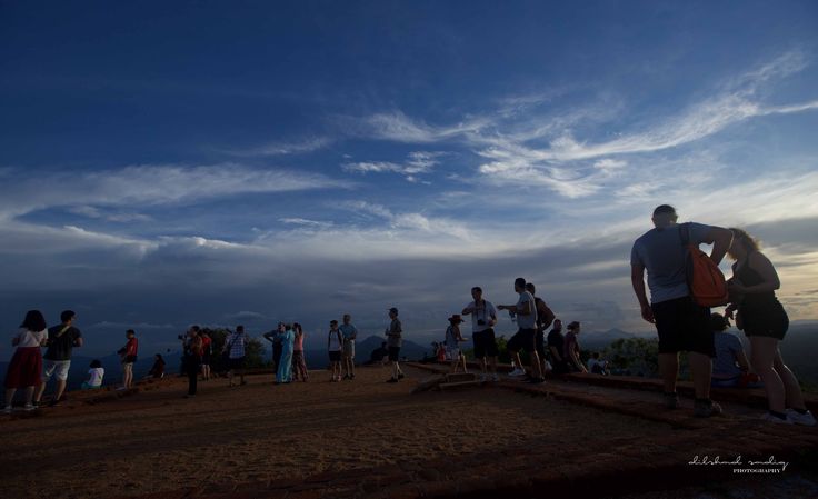 a group of people standing on top of a hill