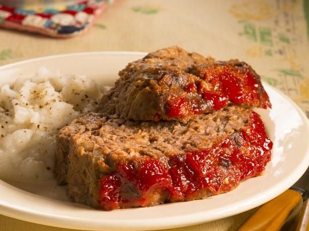 two slices of meatloaf on a plate with mashed potatoes