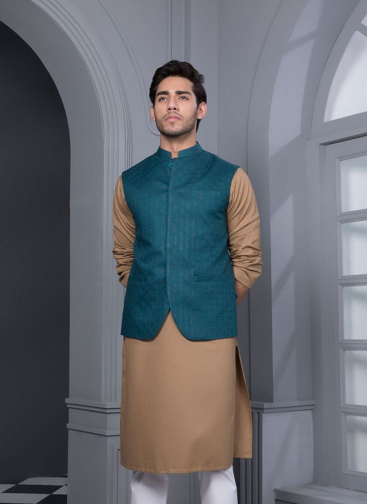 Waistcoat : Made from a regal viscose linen blend, this band neck and embroidered waistcoat is perfect for festive events. Details : Embroidered Front, Embroidered Back, Band Neckline Fabric : Viscose Linen Blend Country of Origin : Pakistan Care Instruction : Should be washed in gentle cycle and hung to dry. Color may bleed so please be mindful of other items with it. Disclaimer : Actual sizes might be slightly different from the size chart. Festive Fitted Kurta With Band Neckline, Tailored Kurta For Festive Occasions, Sleeveless Embroidered Nehru Jacket For Eid, Elegant Cotton Nehru Jacket For Festive Occasions, Green Fitted Kurta With Stand Collar, Green Nehru Jacket With Stand Collar For Festive Occasions, Tailored Nehru Jacket For Festive Occasions, Eid, Formal Embroidered Cotton Nehru Jacket, Tailored Nehru Jacket For Festive Eid