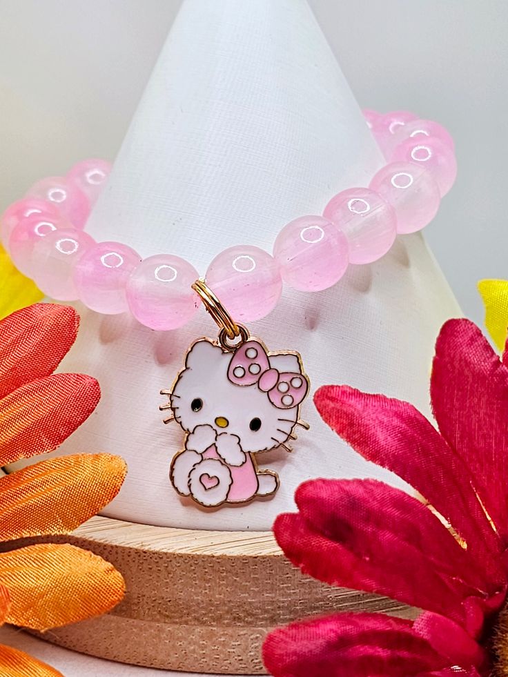 Pink gemstone charm bracelet. Did you know that every purchase comes with a HK pouch filled with stickers? Purchases over $10.00 come with stickers and a small surprise.  Purchases over $20.00 come with stickers and 2-small surprises.  (Small surprises and stickers vary based on availability). Cute Charm Bracelet With Removable Charms As Gift, Hello Kitty Jewelry For Valentine's Day Gift, Hello Kitty Adjustable Jewelry For Gifts, Adjustable Hello Kitty Jewelry As Gift, Adjustable Hello Kitty Jewelry Gift, Trendy Cat Design Jewelry For Gift, Trendy Cat Design Jewelry Gift, Pink Charm Bracelet With Round Beads As Gift, Pink Charm Bracelet With Round Beads For Gift