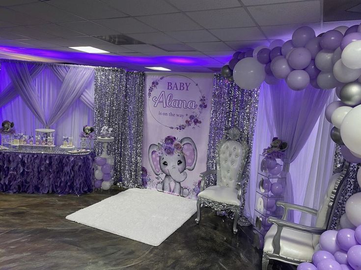 an elephant themed baby shower with purple and silver decorations