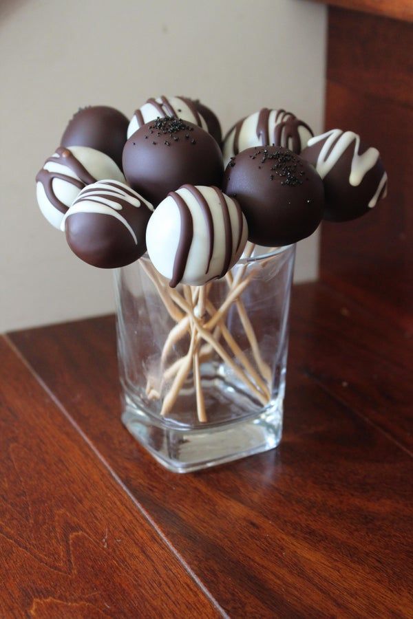 chocolate covered candies in a glass vase on a table