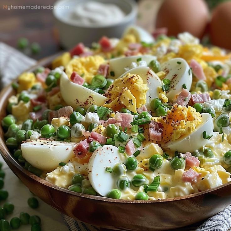 a bowl filled with eggs, peas and ham