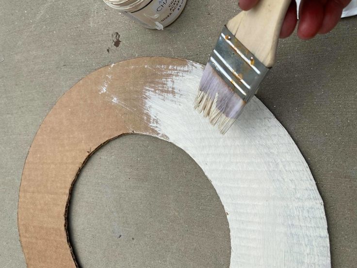 someone is painting a circle with white paint