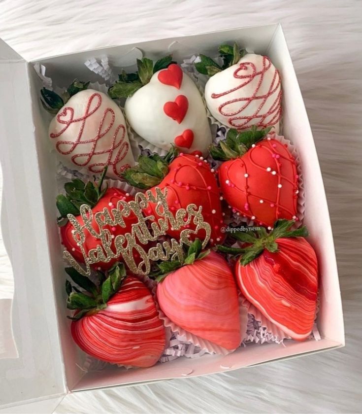 a box filled with chocolate covered strawberries and topped with happy valentine's day decorations