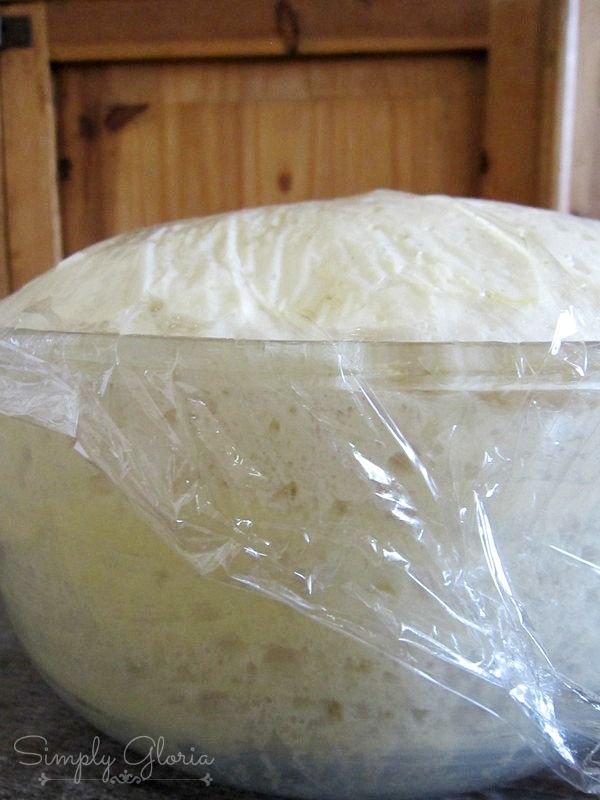 a plastic bag sitting on top of a counter next to a white bowl filled with food