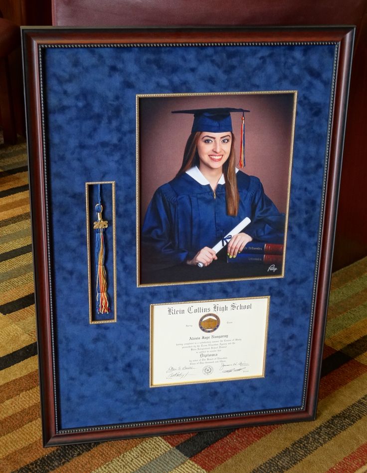 a framed photo of a woman in graduation gown and cap with a tassel on her lap