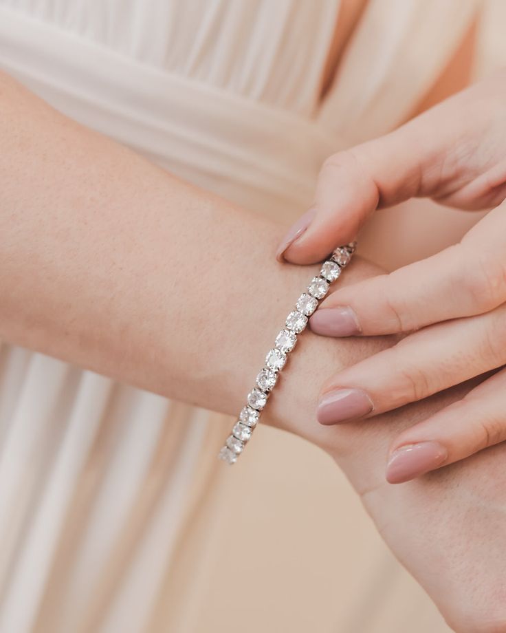 The perfect accessory for any bride that wants a bit of sparkle, our Presley CZ Bracelet can be worn on its own or layered with another piece. Designed with a single strand of round, sparkling cubic zirconia stones, this bracelet will shine on long after your wedding day. Cubic zirconia 1/8" wide; 6"-7" length Includes matching detachable extender Hypoallergenic, lead-free & nickel-free Style #4900 Classic Diamond White Crystal Bracelet For Wedding, Dazzling Tennis Bracelet With Sparkling Stones For Wedding, Wedding Tennis Bracelet With Diamond Accents, Classic Cubic Zirconia Crystal Bracelet For Wedding, Wedding Crystal Tennis Bracelet With Brilliant Cut, Classic Wedding Tennis Bracelet With Sparkling Stones, Elegant Wedding Crystal Bracelet With Brilliant Cut, Wedding Tennis Bracelet With Sparkling Stones, Glamorous Wedding Bracelets In Cubic Zirconia