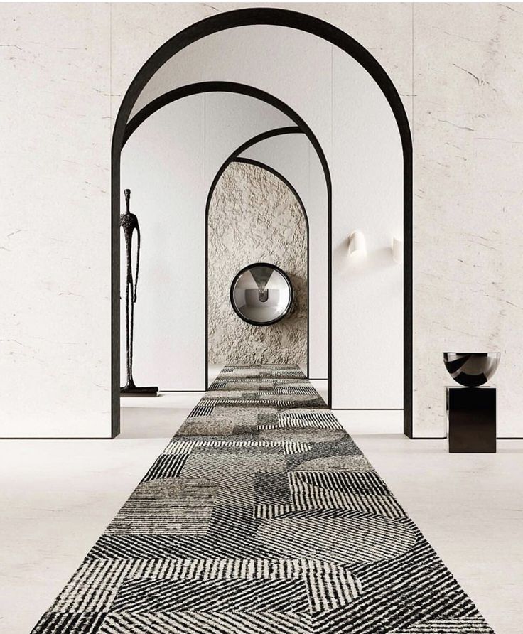 a long carpet with an arch in the middle and a round mirror on the wall