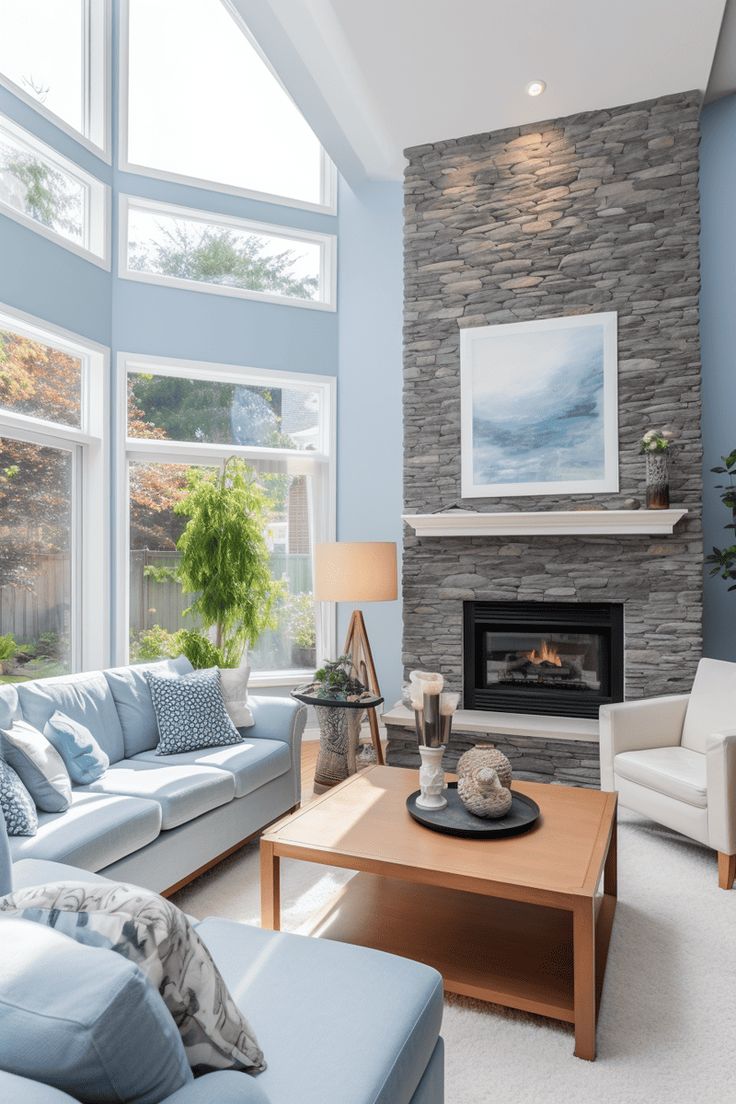 a living room filled with furniture and a fire place in front of a large window